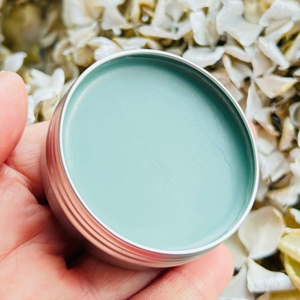 Calm Balm with flowers in background