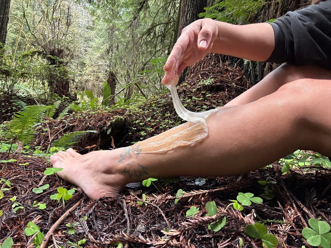 Myra sugaring her legs in the forest