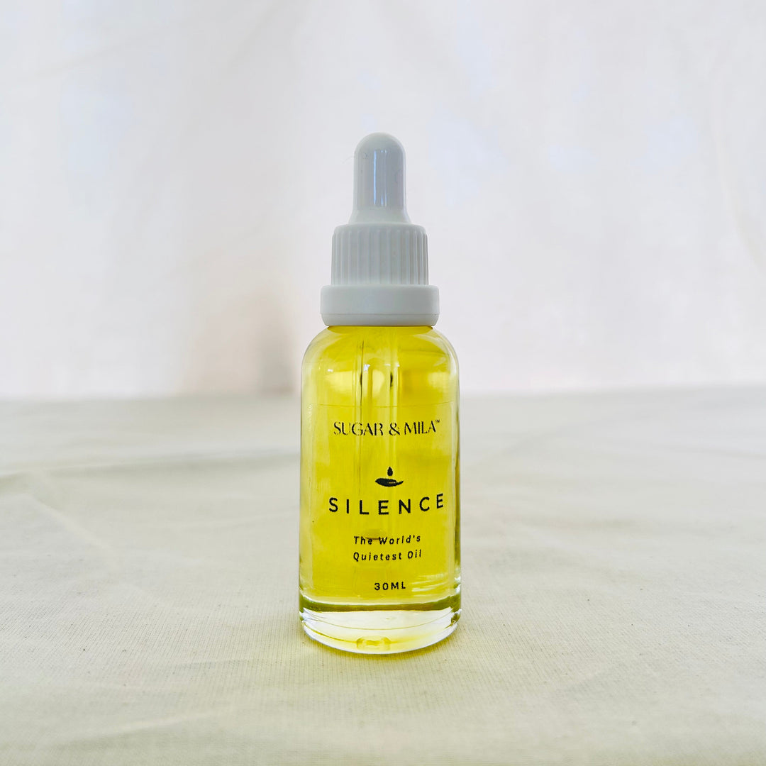 Bottle of 'Silence' oil with a dropper on a white background