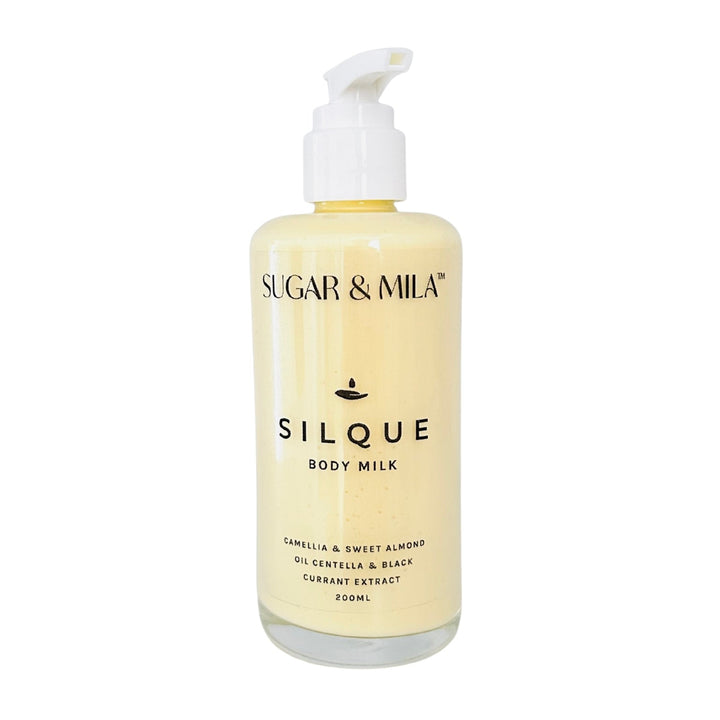 Bottle of Sugar & Mila Silque Body Milk on a white background